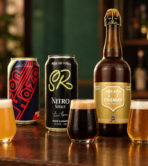 Philter Neon Haze Hazy IPA, Sunday Road Nitro Stout and Chimay Dorée arranged on a timber table with three beer tasting glasses.
